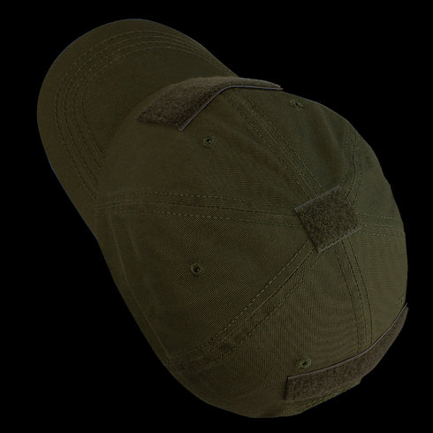 The Condor Tactical Cap - MultiCam Tropic is a dark green baseball cap with multiple Velcro patches, shown from an angled top view.